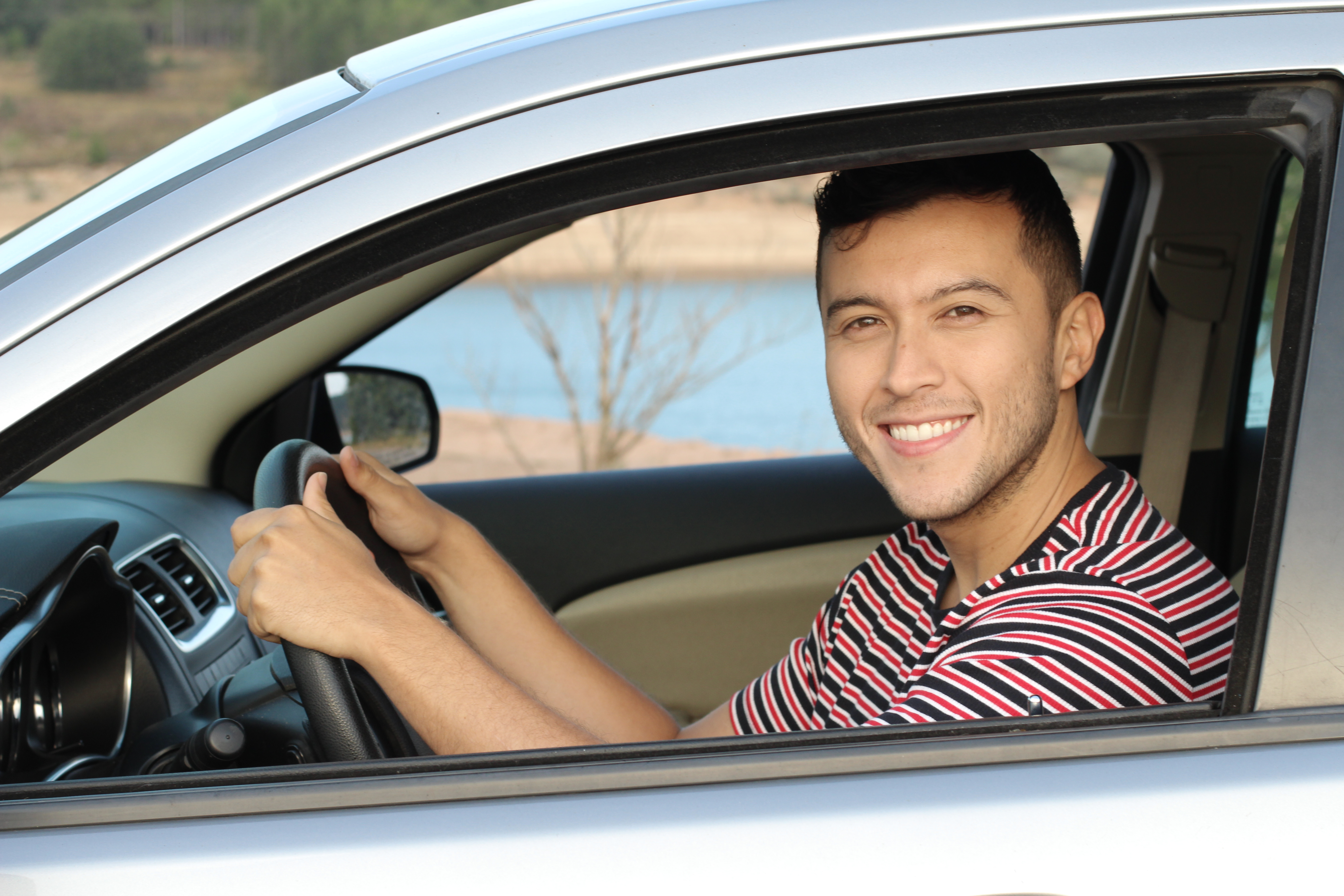 hispanic_man_driving_car_drivers_seat