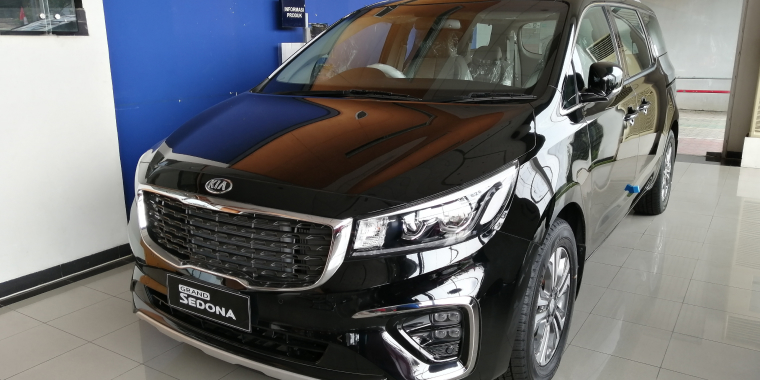 Kia Sedona car on display at a showroom.